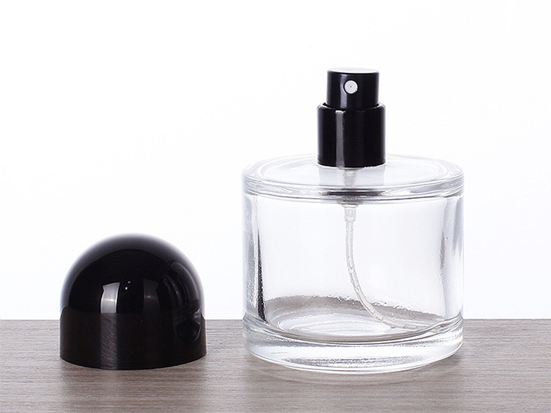 Transparent glass cylindrical perfume bottle with lid