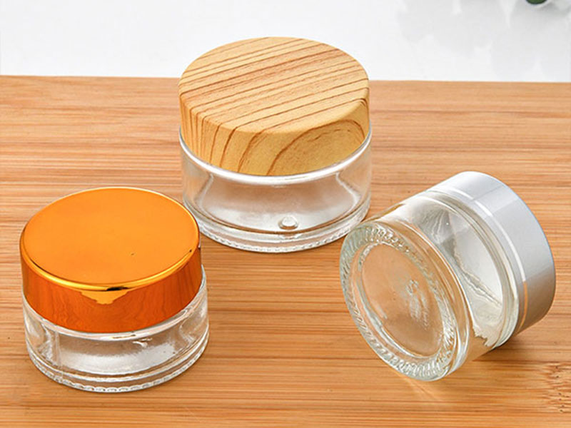 Clear glass cream jar with cap